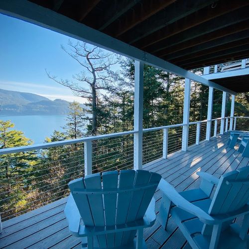 Lower deck and seating for both guest bedrooms on the lower level.   Views of East Sound and Crescent Beach for those quiet mornings..