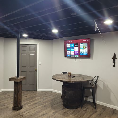 LOWER LEVEL:  Fully finished lower level with multiple sofas, multiple televisions, a foosball table, dartboard, and an air hockey table.