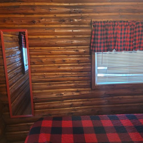 Bedroom #1:  features a queen-size bed, nightstand, lamp, mirror, dresser, and clothes rack.
