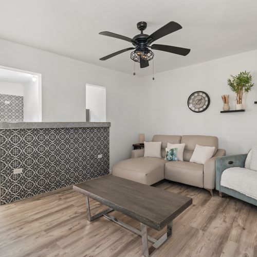 Chic tiled breakfast bar connects the living space to the kitchen.