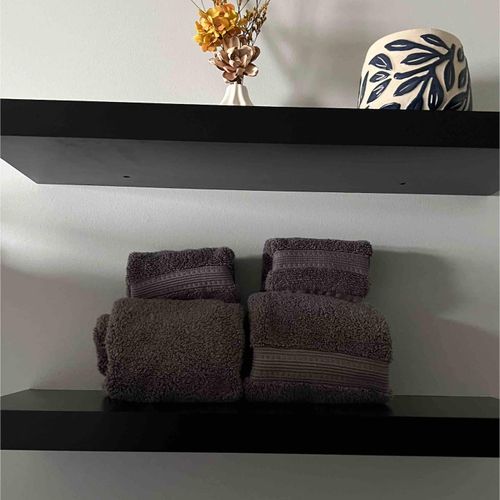Neatly folded towels stacked & ready, so you can settle in & feel right at home.