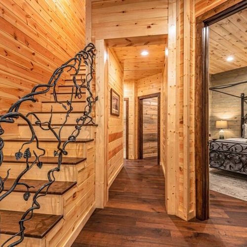 The staircase to the second floor features an intricate hand rail.
