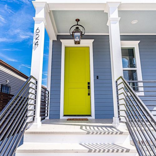 Cheerful yellow front door welcoming you home in style.
