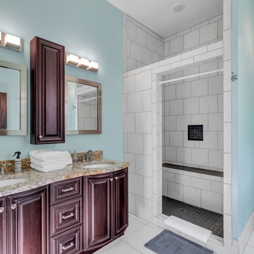 Bathroom w/ shower, elegant vanity & plenty of space to get ready.