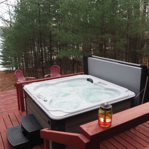 Overall:  the wonderful new year-round hot tub / spa with the private lakefront in the background.