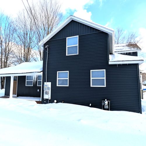 EXTERIOR:  The side of the house in Winter