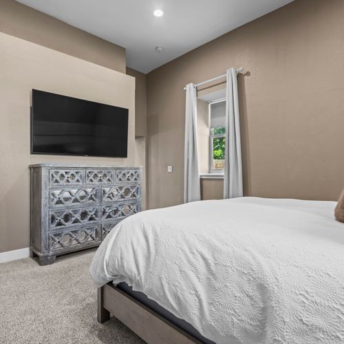 Catch your favorite shows from the comfort of the main bedroom.