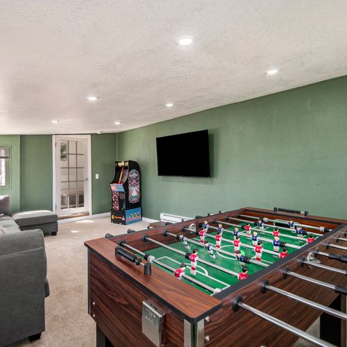 Lively living room scene featuring a foosball table, adding a fun and interactive element to the space.