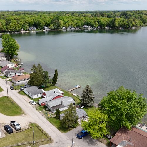 Exterior:  a side drone shot of the  house with the lake