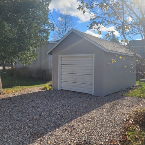 Exterior:  the detached garage (not available for guest usage) and the small  driveway.