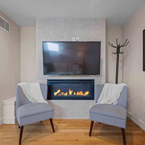 Living room centered around a warm fireplace.