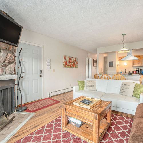 Enjoy mountain sunsets from the couch—fireplace, tv, and soft lighting set the mood.