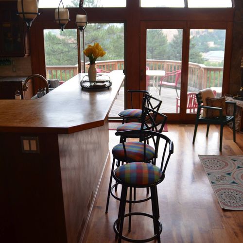 The east-facing wall in the dining area is lined with large windows that bathe the space in natural light, immersing you in the tranquility of nature.