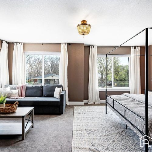 - spacious bedroom with king canopy bed and sitting area for morning coffee or reading
- neutral decor, large windows, and cozy textures create a calming escape
- perfect balance of functionality and relaxation with extra room to spread out