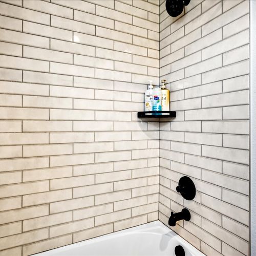 - refresh in this stylish tub shower combo with matte black fixtures and bright subway tile
- wall shelf keeps essentials handy while you soak or rinse off
- crisp modern design perfect for both quick showers and relaxing baths