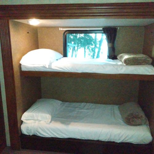 Bedroom #2:  includes 3 twin beds, a dresser, and a television.