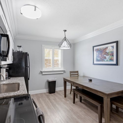Dining area w/ a wood table — great for gathering over a shared meal.