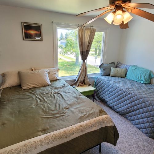 Bedroom #2 ( second floor):  features a full-size bed, a twin bed, a ceiling fan, and a closet.