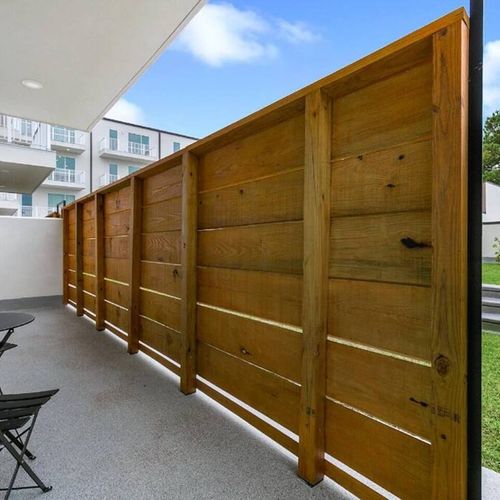Enclosed outdoor patio w/ wood privacy fence — your own quiet retreat.