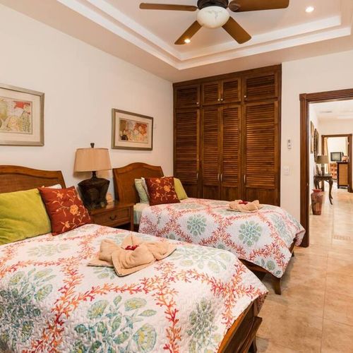 The second bedroom is furnished with two twin beds.