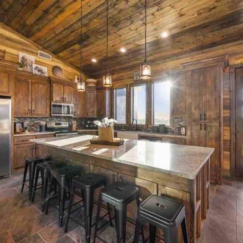 You are seamlessly taken into the kitchen which has 6 bar top seats!