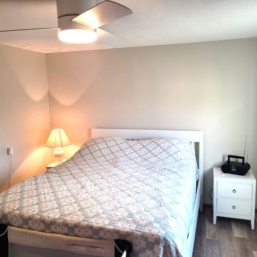 BEDROOM #2:  Features a queen-size bed, crib, ceiling fan, closet, nightstands, lamp, mirror, and a private desk and television