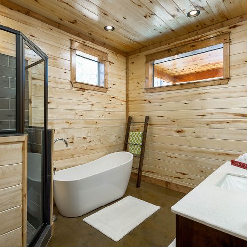 The private master bathroom has a walk-in shower and oversized soaking tub.