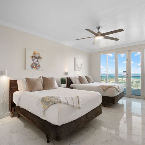 Comfortable and chic! Two plush beds await, with beautiful ocean views and charming decor for a delightful stay.