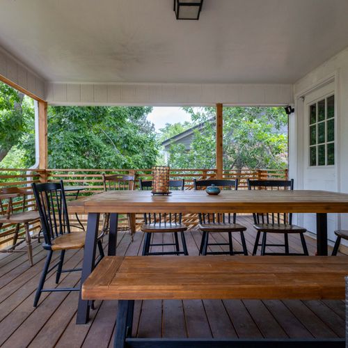 Eat, laugh, repeat—at this breezy wooden table under open skies.