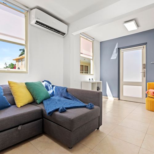 Kick back and watch your favorite shows. The living room features a large smart TV and stylish decor for ultimate relaxation and entertainment.