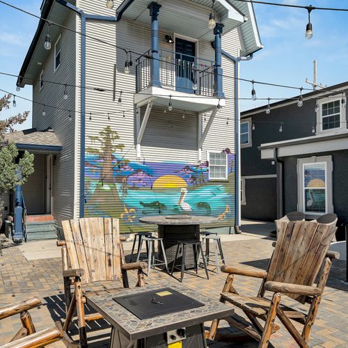 Gather around the fire pit with friends in this charming courtyard, featuring a colorful mural that captures the spirit of New Orleans.