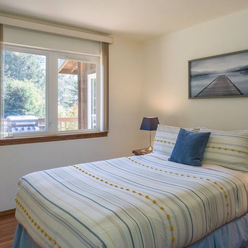 Guest bedroom with a full bed and garden view.
