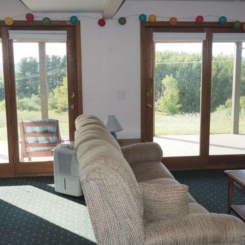 Living room #2 (lower level):  features a sofa and loveseat, bar area, and 3 single beds.