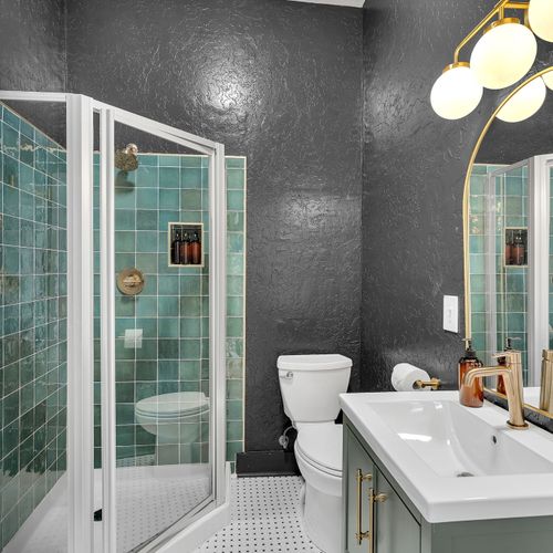 Moody and modern bathroom with a walk-in shower, offering both style and convenience for your stay.