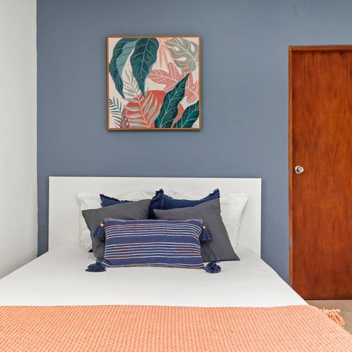 Sleep in style! This beautiful bedroom features a calming color palette and a cozy bed, designed for ultimate rest and rejuvenation.