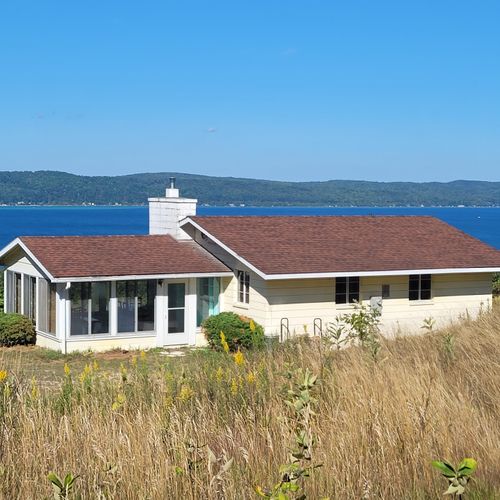 Exterior:  another view of the cottage with crystal lake in the background.