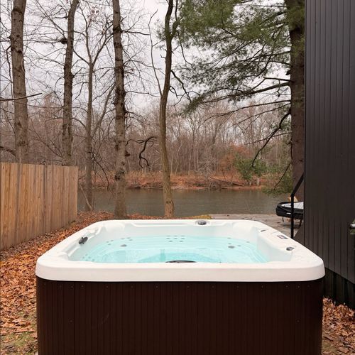 Enjoy the hot tub with river views, just steps off the back porch.