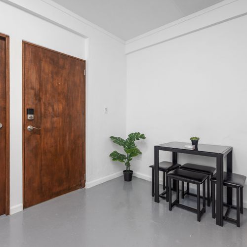 Condado | Puerto Rico Vacation Rental 34 Tasteful Dining Experience: Gather around this stylish dinner table, designed for comfort and conversation, offering the perfect setting to savor delicious meals in a contemporary and inviting atmosphere.