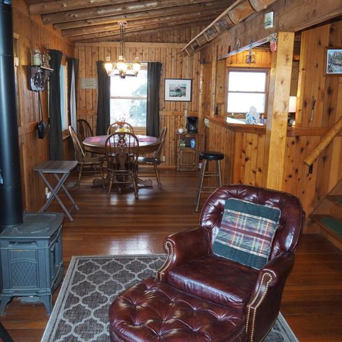 Living room:  the cabin has a very cozy and comfortable living room with a sofa, comfy chair, desk, book cabinet, gas fireplace, and a television with live streaming via roku.