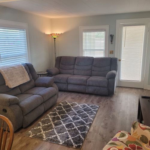 Living room:  the cottage has a very comfy living room with a sofa, loveseat, comfy chair, ceiling fan, and live streaming television.