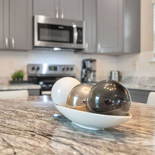 Sleek kitchen countertop w/ modern décor touches that elevate the whole space.