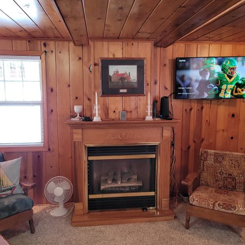Overall:  the very cozy and woodsy living room with a gas fireplace and live streaming television.