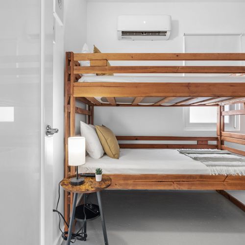 Discover minimalist comfort in our modern bunk bed room, designed for simplicity and efficiency.