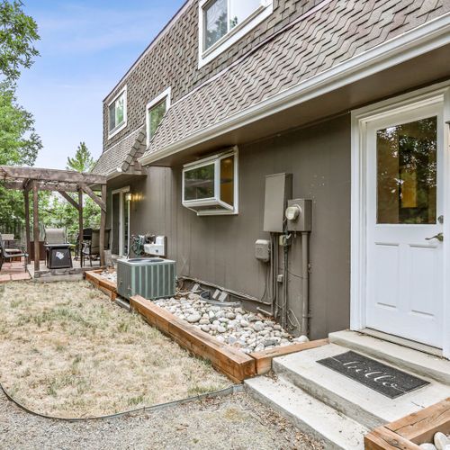 Immerse yourself in the surrounding greenery, complete with inviting outdoor furniture and a warm firepit. Please note the pergola has been removed.