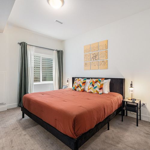 Enjoy deep sleep in this bedroom with a king size bed that feels open, tidy, and refreshingly calm.