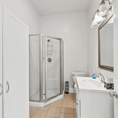 Bright and modern bathroom with a walk-in shower, offering both style and convenience for your stay.