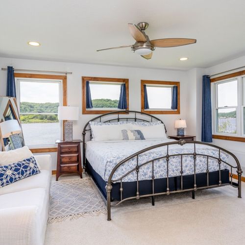 Bedroom #1 (second floor):  the home has a gorgeous master bedroom with a king-size bed, sofa, ceiling fan, dresser, closet, great views of betsie lake, and its own private en suite bathroom with a jetted tub!