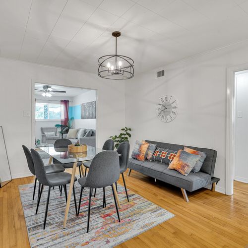 Gather around for a meal or a game night in this stylish dining space, complete with a modern futon and inviting decor. Perfect for making memories with family and friends!