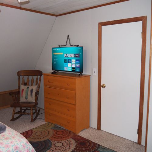 Bedroom #4 (second floor):  features 3 twin-size beds, nightstands with lamps, ceiling fan, closet, dresser, chair, and its own private television.