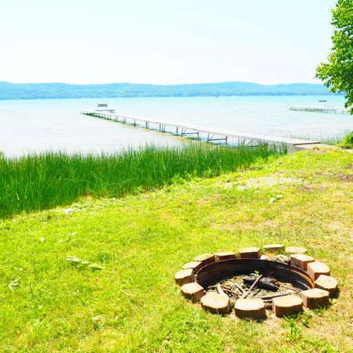 Exterior:  the backyard bonfire ring with the dock in the background.